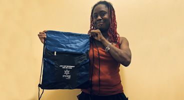 Young lady holding an NFB of Georgia backpack.