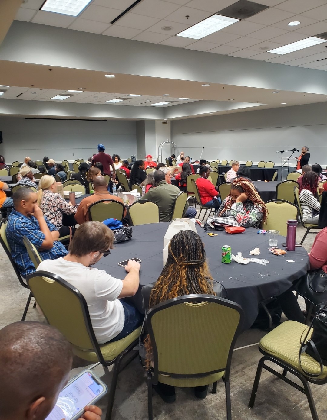 The NFB of Georgia members and Guest seated at tables during a State Convention gathering.